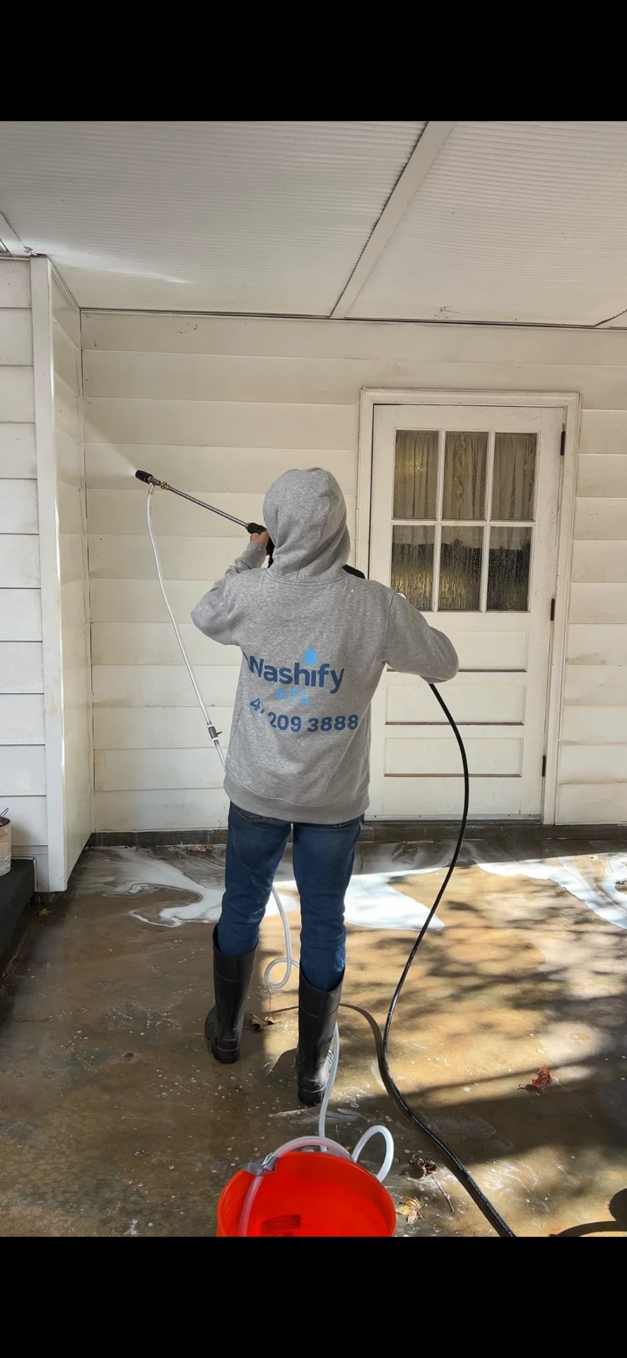 WashifyATL soft washing a covered porch and railings