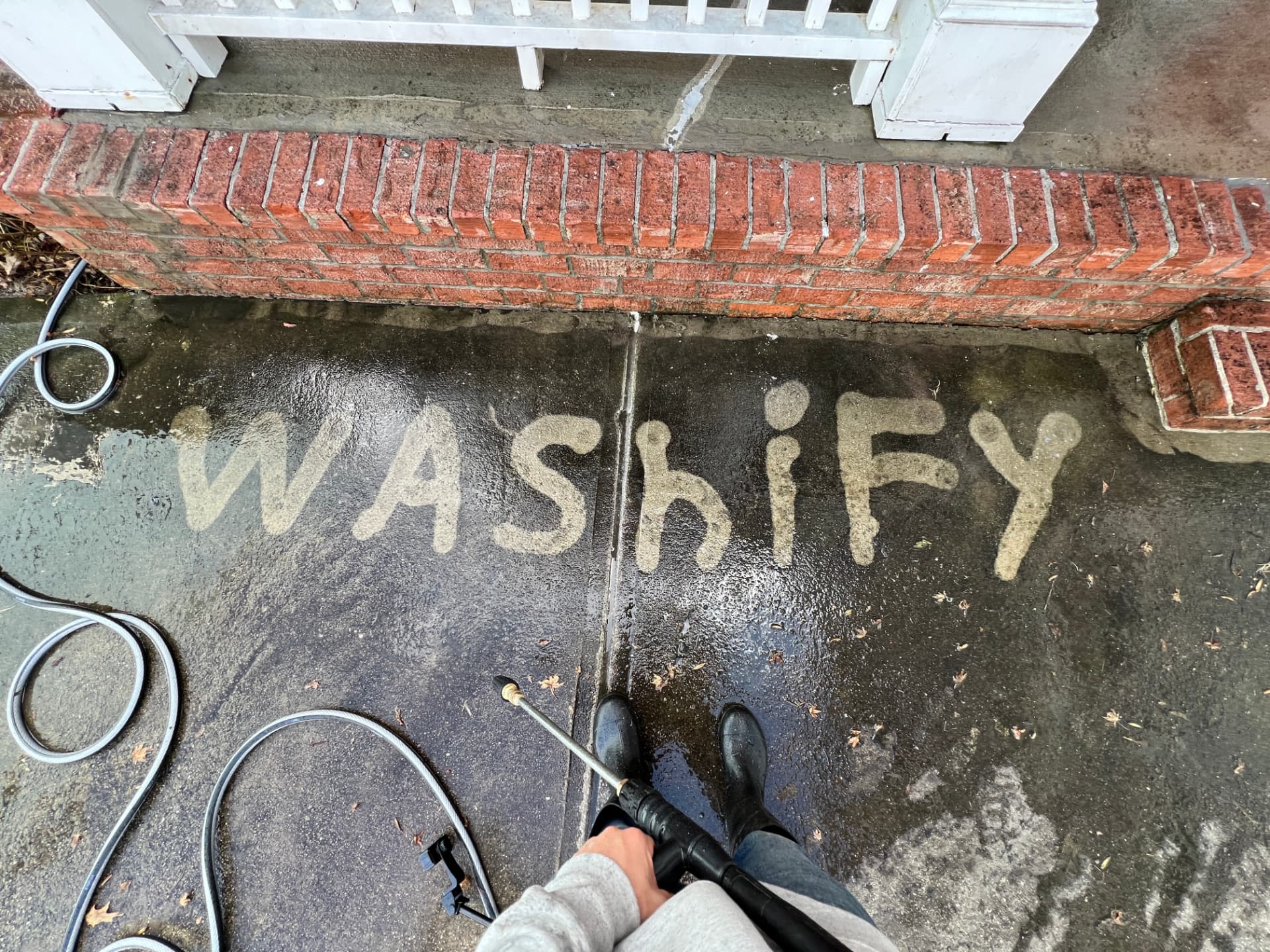 Washify written in the grime of a dirty concrete walkway